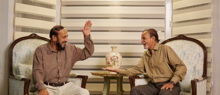 Two senior men chatting in the lounge at Senior Circle