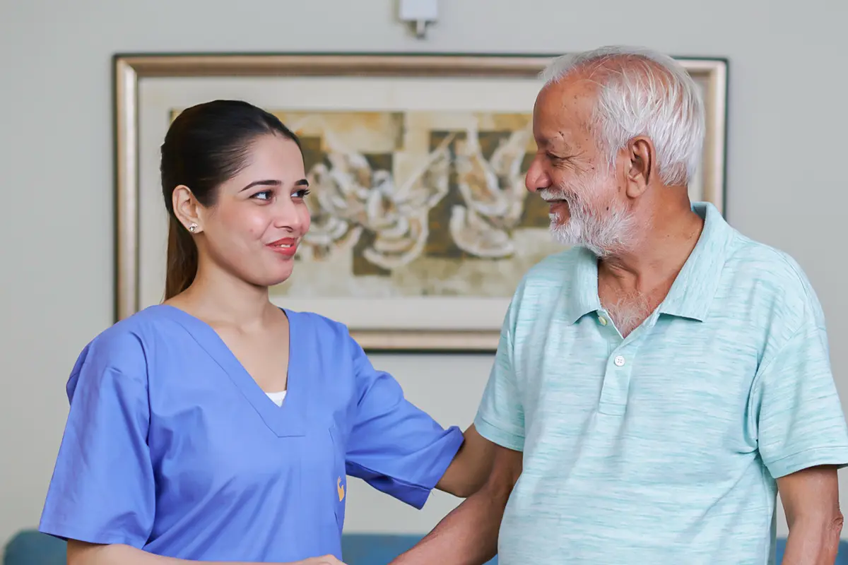 Senior Circle nurse sharing a smile with a senior man