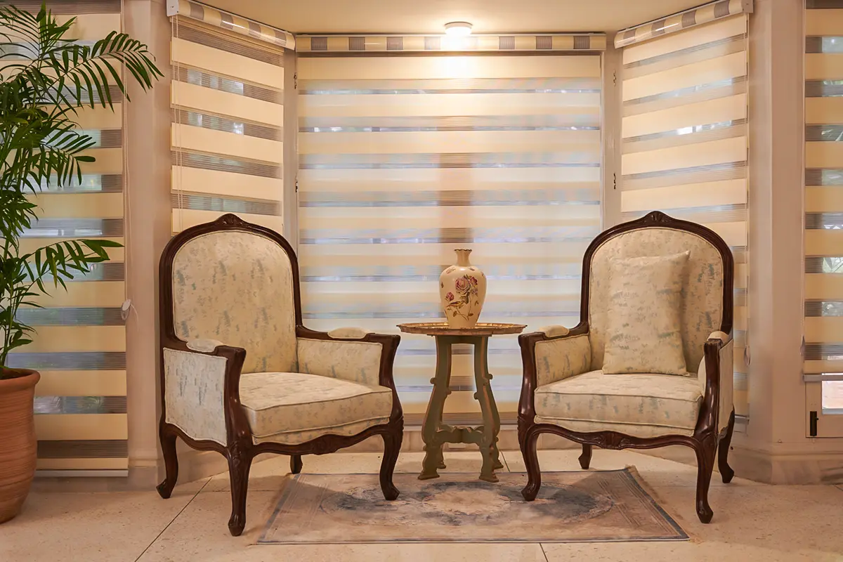 Quiet sitting area with armchairs at Senior Circle, Karachi