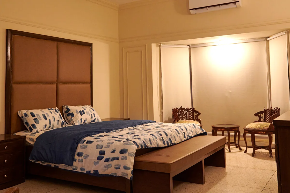 Spacious private bedroom with seating area at Senior Circle assisted living